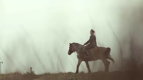 Military Man Guards The Territory On Horseback. Soldier On Duty In The Field