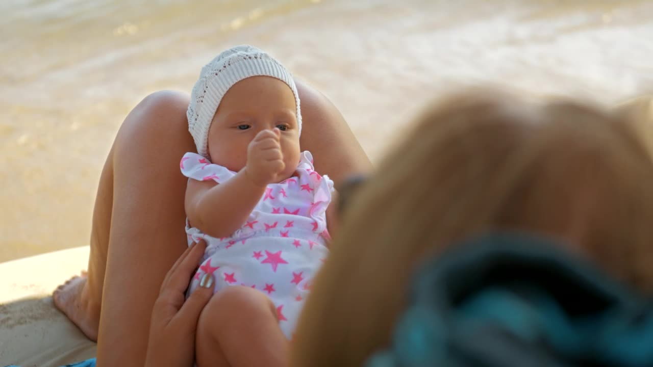 Mother and her baby on a sunbed