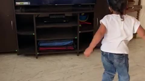 a little girl is dancing funny.