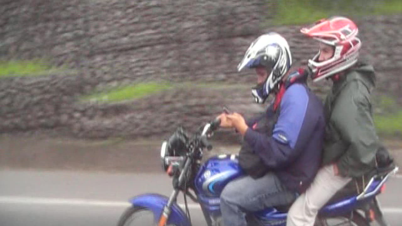 Motorcyclist texting while driving in Costa Rica