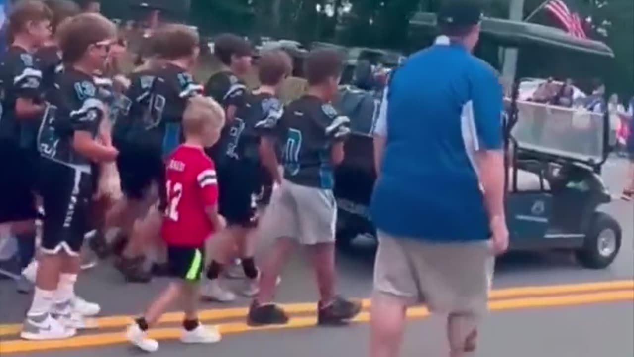 New Hampshire small town parade when the wildcat youth football teams pass a Trump sign go bananas