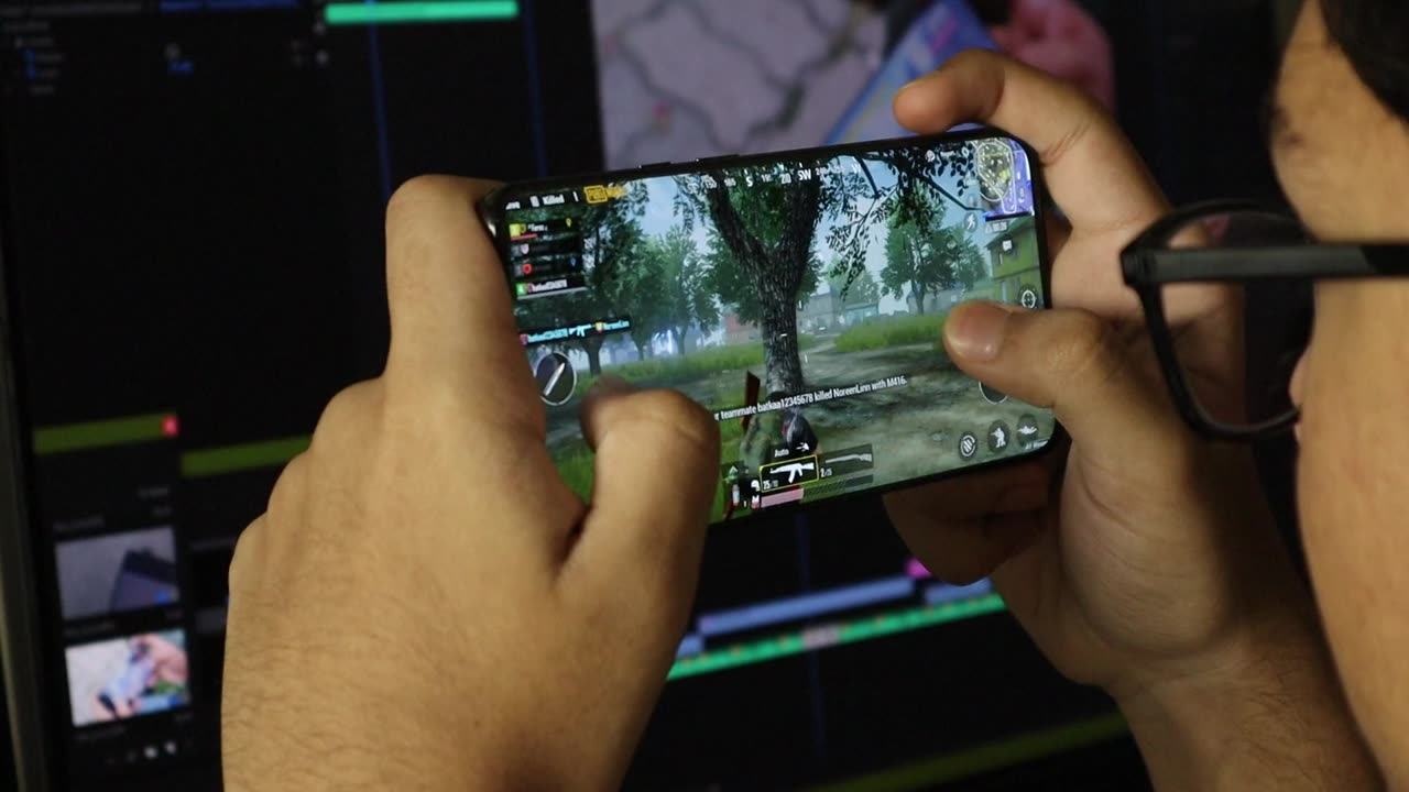 A Young Man Playing A Mobile Game