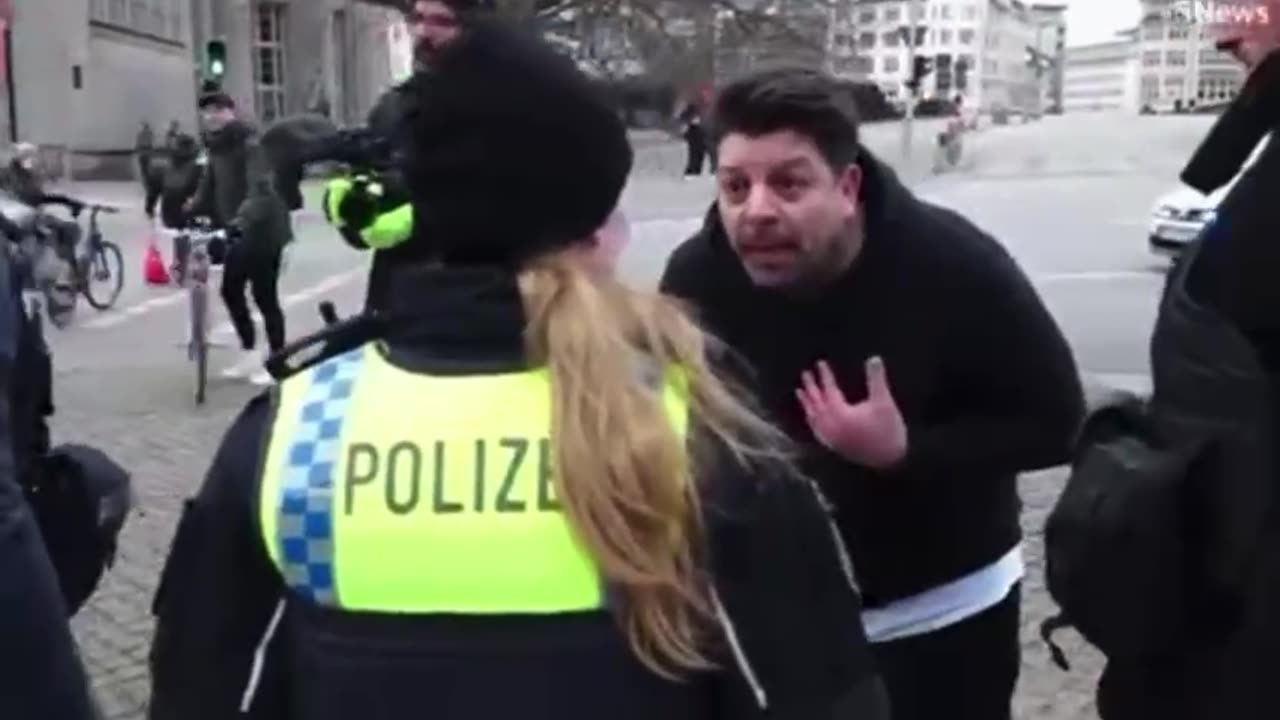 Furious driver PUNCHES eco-protester after zealots glue themselves to the road