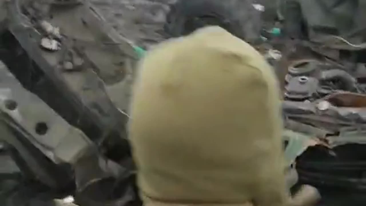 Ukrainian troops passing destroyed Ukrainian convoy