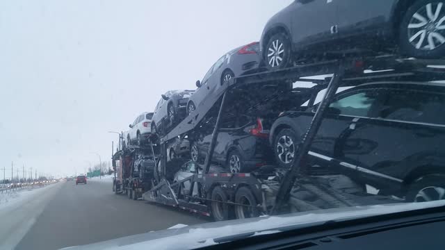 Man trying to pass over the big loading car truck on a highwway