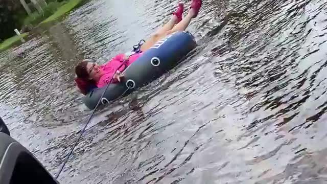 Woman goes tubing in the streets of Florida during Tropical Storm Eta