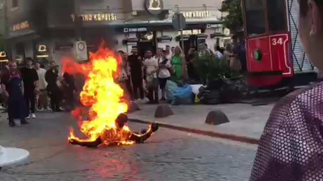 Man wearing a Grim reaper costume set himself on fire in front of the Galata Tower in Istanbul