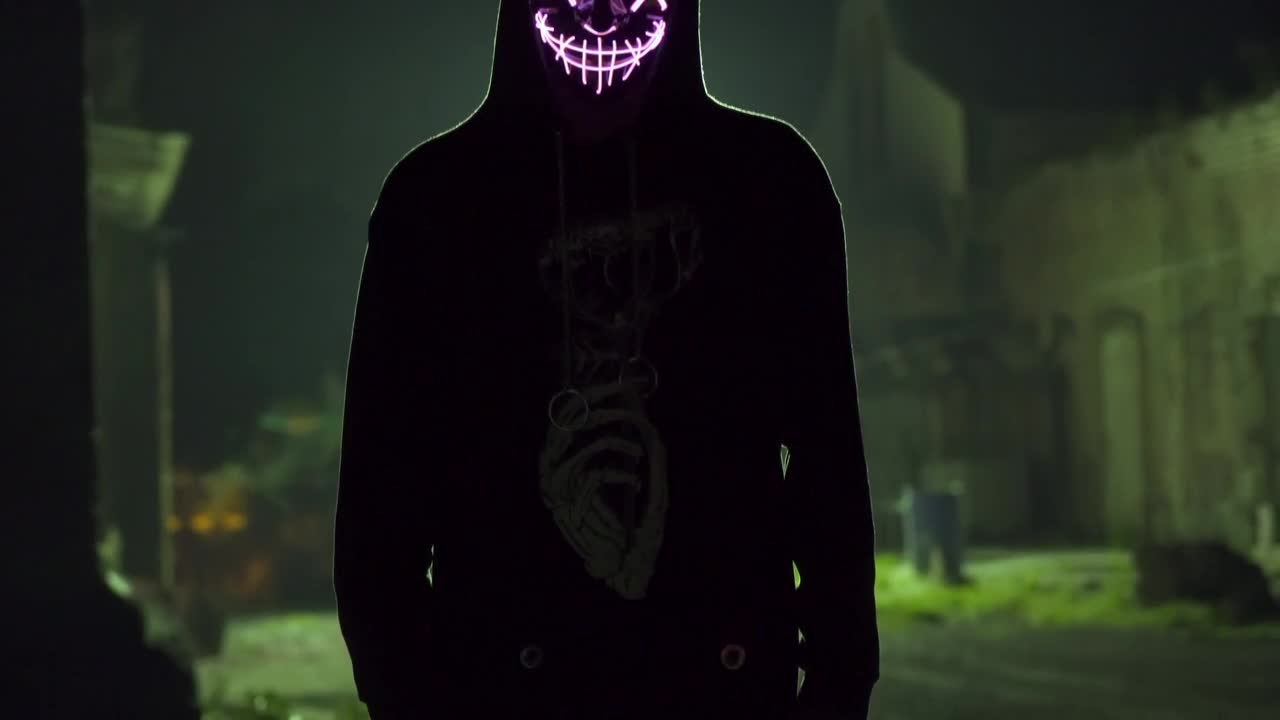 Silhouetted man with LED light mask