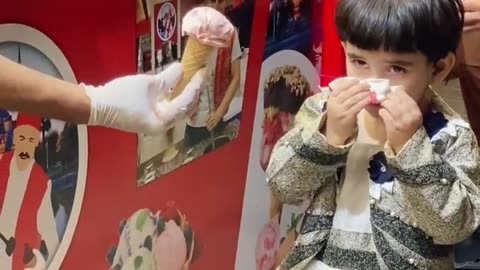 Cute baby with Ice cream shopkeeper