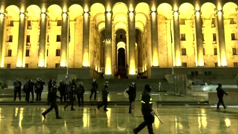 Protesters shield woman outside Georgia parliament