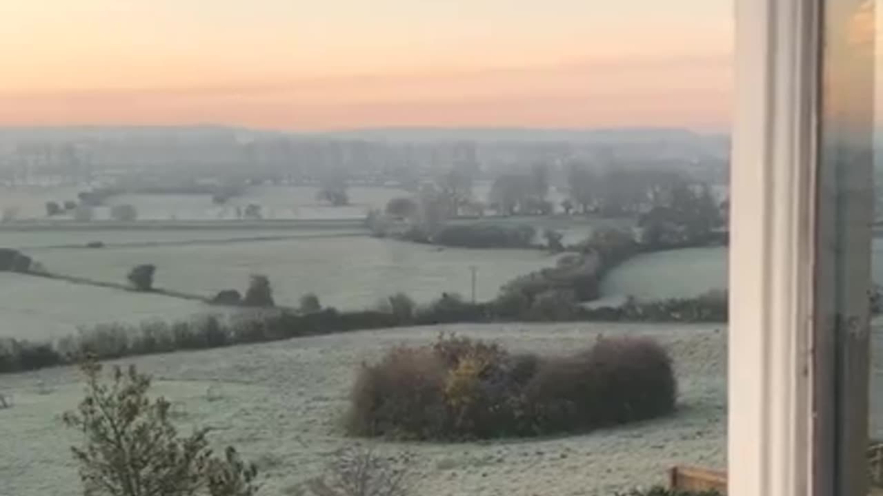 Sun rises over the frosty fields of the Sacred Isles of Avalon in Glastonbury.