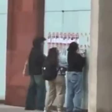 Students at New York university rip down posters of the missing people that Hamas took hostage