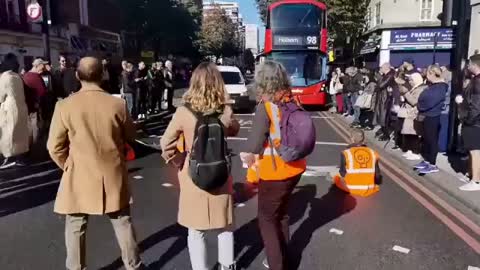 London. A "Just Stop the Oil" protester sit in the road on Regent Street today.