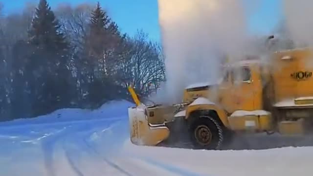 Old SnoGo Truck Launching Snow High into the Air