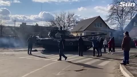 Fearless Ukrainian man kneels in front of marauding Russian convoy in Tiananmen tank moment