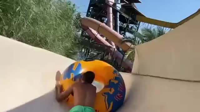 Two Friends Goofing Around On Waterslide