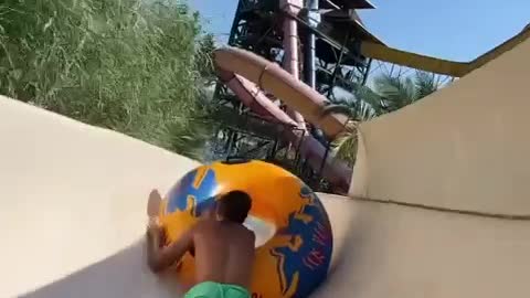 Two Friends Goofing Around On Waterslide