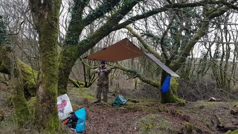 taking off the guy lines onthe tarp. Dartmoor MARCH 2023