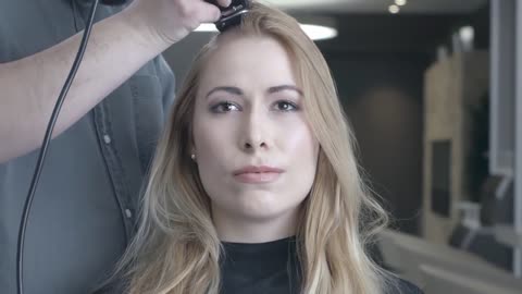 Blonde woman shaves her head for cancer awareness