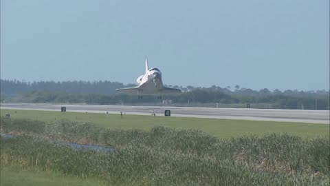 Space shuttle landing on runway