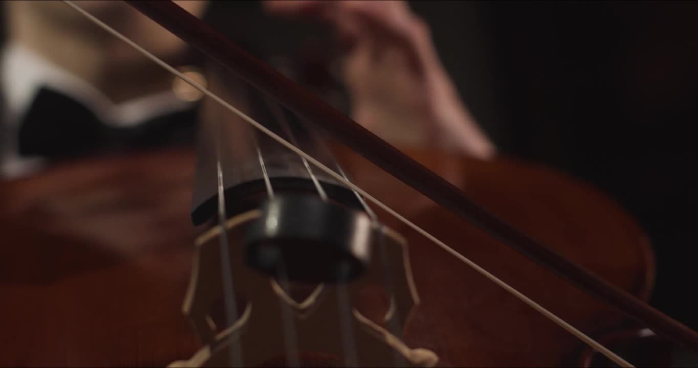 Close Up Hands And Bow Of Male Cellist Playing Cello