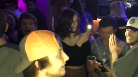 Guy in white hat punches guy in orange hat on cheek