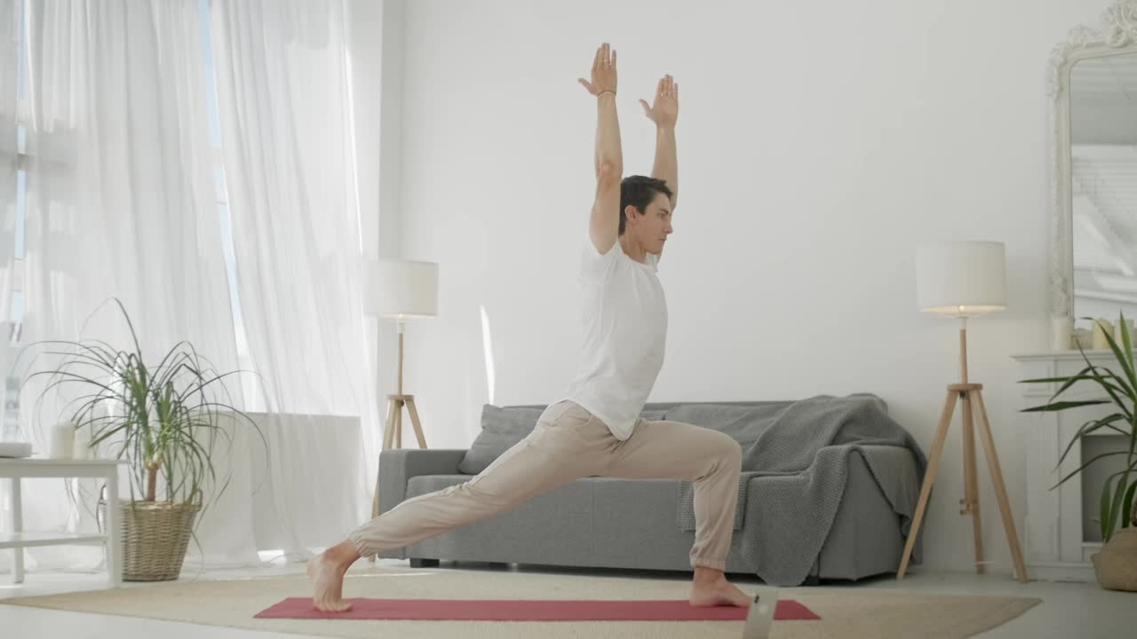 Young man practicing yoga at home