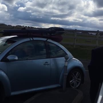 A blue buggie volks wagon car at the beach
