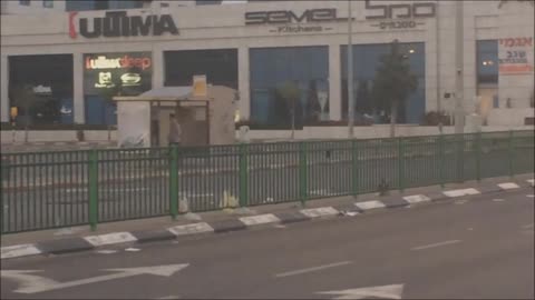 A wacko guy dancing at a bus stop