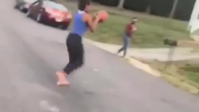 Girl in blue shirt throws basketball hits face