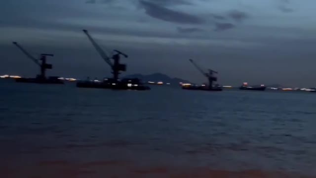 Seaside waves and boats at night