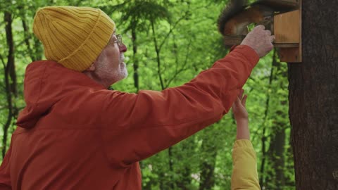 Adult and Child Feeding a Squirrel