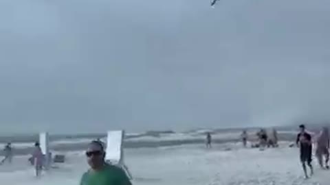 Waterspout sends beachgoers scrambling