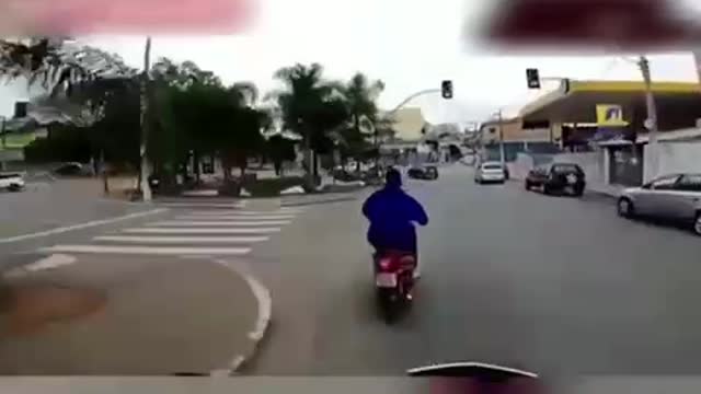 biker get scared by the motorcycle cop and fall