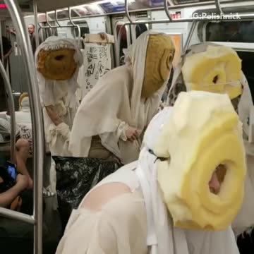 Weird white cult costumes with bread bagel egg omelette face masks subway