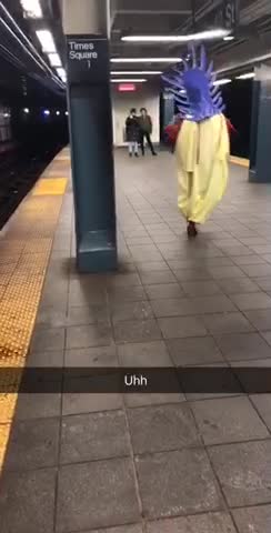 Uhh person in purple mask and costume dancing on platform