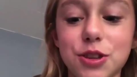 Pet Parrot helping girl to remove her teeth.