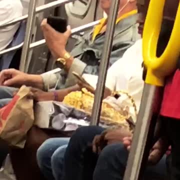 Man subway sitting really big black hat