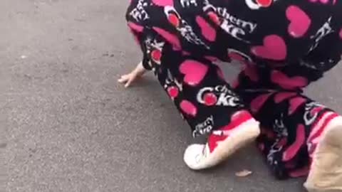 Girl in pink pajamas tripped over dog
