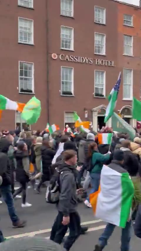 People protesting on the streets of Dublin, Ireland against the influx of immigrants.