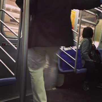 Man black suite coat kicking subway door while it moves