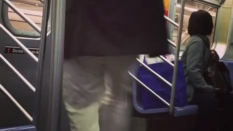 Man black suite coat kicking subway door while it moves