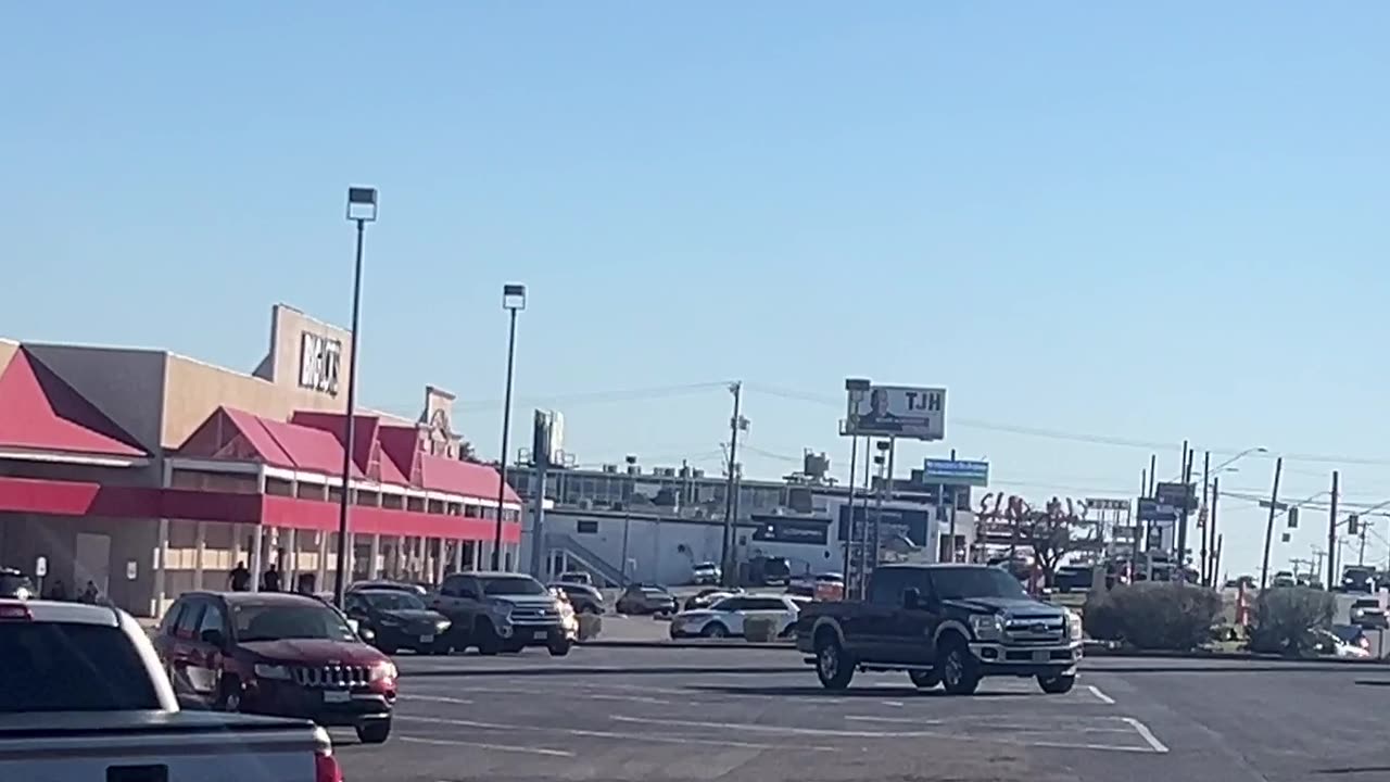 head fake on a white passenger van enters the shopping center