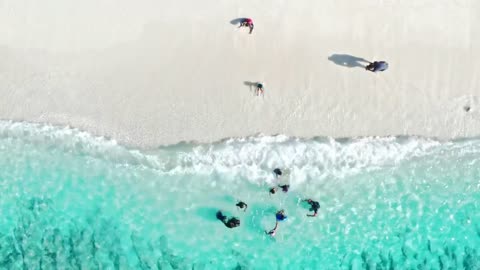 Children on a beach with waves