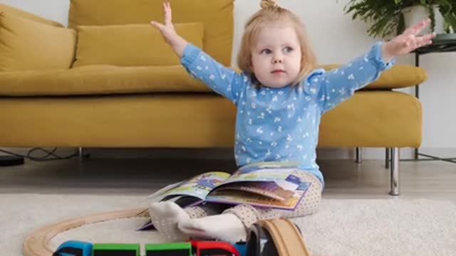 A beautiful and cute girl watching a book