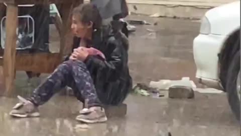 Little girl crying in the rain as she couldn't sell her food items