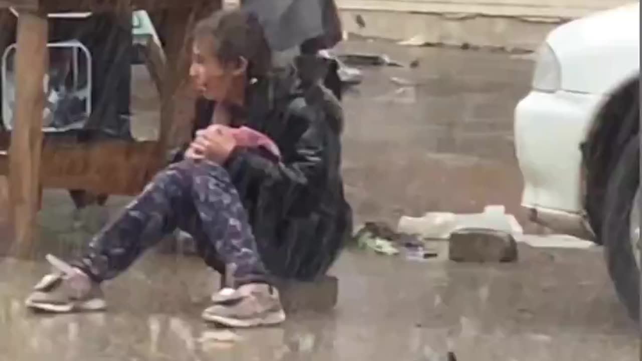 Little girl crying in the rain as she couldn't sell her food items