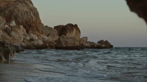 sea waves hitting a cliff