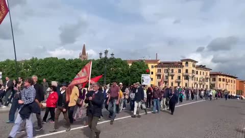 Crowd chanting "NATO is a killer" and carrying banners insulting Biden