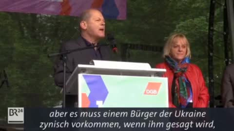 Germany's Chancellor Scholz had to shout over loud protesters